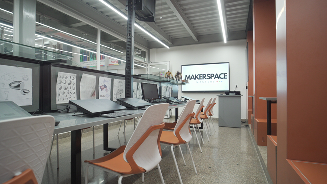 A modern makerspace lab with computers and workstations.